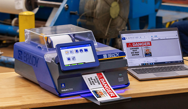 J7300 printer on a desk in a manufacturing facility.
