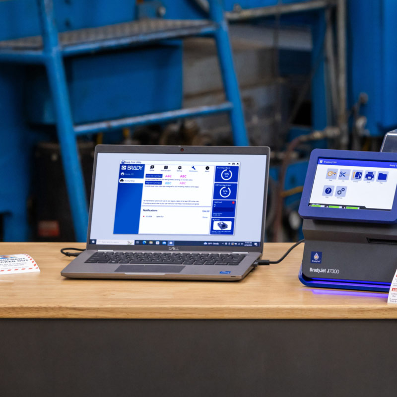 A laptop connected to a J7300 is displaying a screen from Brady Workstation.
