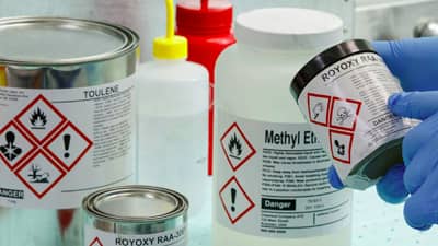 A number of containers with Brady GHS labels applied to them to identifying safety hazards.