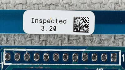 A circuit board with a Brady glossy polyimide label that is designed to endure the high temperatures of both reflow and non-reflow processes.