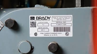 A Brady metallised polyester label with barcodes and other information applied to a piece of equipment.