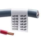 A close-up of a Brady wrap-around label on a gray cable. The label is white with black text that is repeated for easy recognition.