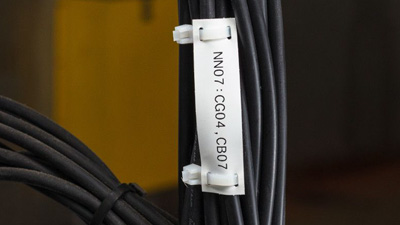 A tear-resistant tag attached to a bundle of wires.