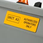 A yellow label identifying a a piece of equipment.