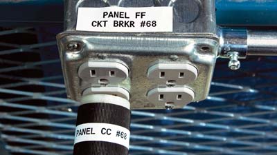 Brady multi-purpose vinyl labels applied to an outlet and equipment plug to identify their usage.