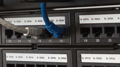 A number of Brady patch panel strip labels identifying the ports of a patch panel for easy identification.