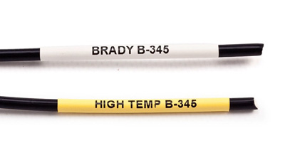 Two wires with sample high-temp heat shrink labels - one white one yellow - applied to them.